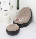 Inflatable seat with foot rest and a pump